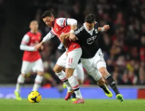 Arsenal V Southampton 2013-14 Prints: Mesut Ozil vs Jose Fonte: A Footballing Battle at Arsenal vs Southampton (2013-14)