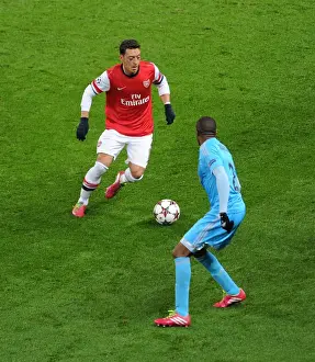 Arsenal V Marseille 2013-14 Prints: Mesut Ozil vs Kassim Abdallah: Intense Battle at Arsenal v Marseille
