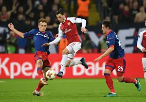 CSKA Moscow V Arsenal 2017-18 Prints: Mesut Ozil vs. Konstantin Kuchaev: A Battle in the Europa League Quarterfinals between CSKA Moscow and Arsenal FC