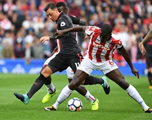 Stoke City V Arsenal 2017-18 Prints: Mesut Ozil vs Kurt Zouma: A Premier League Face-Off