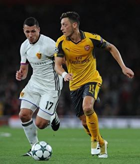 Arsenal V FC Basel 2016-17 Prints: Mesut Ozil vs Marek Suchy: A Football Battle at Arsenal's Emirates Stadium - Arsenal FC vs FC Basel 2016-17