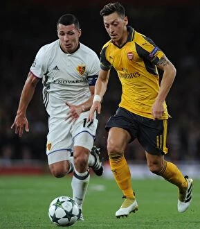 Arsenal v FC Basel 2016-17 Collection: Mesut Ozil vs Marek Suchy: A Battle of Wits at Arsenal's Emirates Stadium - Arsenal FC vs FC Basel