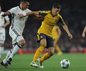 Arsenal V FC Basel 2016-17 Prints: Mesut Ozil vs Marek Suchy: A Fierce Battle in Arsenal's Champions League Showdown