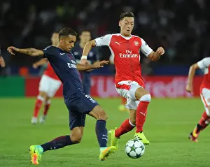 Paris Saint Gernain V Arsenal 2016-17 Prints: Mesut Ozil vs. Marquinhos: A Clash in the UEFA Champions League between Paris Saint-Germain and Arsenal