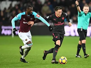 West Ham United V Arsenal 2017-18 Prints: Mesut Ozil vs Pedro Obiang: A Battle in the Heart of the Premier League Clash between Arsenal and West Ham
