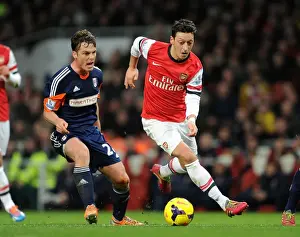 Arsenal V Fulham 2013-14 Prints: Mesut Ozil vs. Scott Parker: A Premier League Face-Off at the Emirates