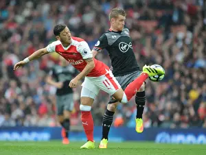 Arsenal V Southampton 2016-17 Prints: Mesut Ozil vs Steven Davis: A Battle in the Arsenal vs Southampton Rivalry