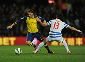 Queens Park Rangers V Arsenal 2014-15 Prints: Mesut Ozil vs. Suk-Young Yun: Clash at Loftus Road