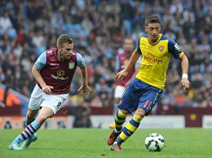 Aston Villa V Arsenal 2014-15 Prints: Mesut Ozil vs Tom Cleverley: A Football Battle at Villa Park, 2014-15 Premier League