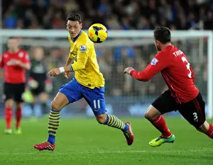 Cardiff City V Arsenal 2013-14 Prints: Mesut Ozil's Magic: Outsmarting Andrew Taylor in the Arsenal-Cardiff Showdown (2013-14 Premier League)