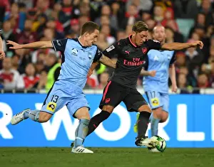 Sydney FC V Arsenal - 2017-18 Prints: Mesut Ozil's Masterful Moves: Outsmarting Brandon O'Neill in Arsenal's Pre-Season Victory