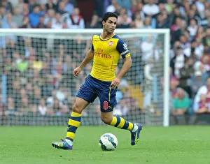 Aston Villa V Arsenal 2014-15 Prints: Mikel Arteta Leads Arsenal Against Aston Villa in Premier League (2014-15)