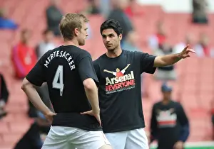 Mikel Arteta and Per Mertesacker (Arsenal) warm up in thier Arsenal for Everyone T Shirt