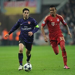 German Soccer League Collection: Mikel Arteta vs. Luiz Gustavo: A Battle in the UEFA Champions League between Bayern Munich
