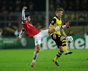Images Dated 6th November 2013: Mikel Arteta vs. Marco Reus: Intense Clash in Borussia Dortmund vs