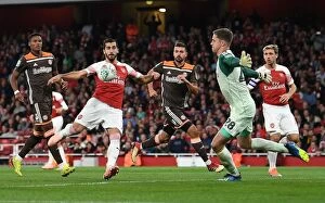 Images Dated 26th September 2018: Mkhitaryan vs Daniels: Intense Moment from Arsenal's Carabao Cup Clash with Brentford