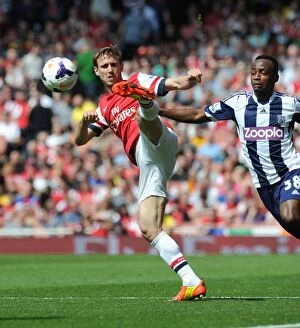 Arsenal v West Bromwich Albion 2013-14 Collection: Monreal vs. Berahino: A Tense Face-Off at Emirates Stadium - Arsenal vs