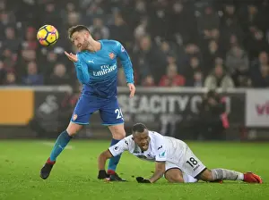 Swansea City V Arsenal 2017-18 Prints: Mustafi vs Ayew: A Battle of Strength and Skill in the Swansea vs Arsenal Clash (2017-18)