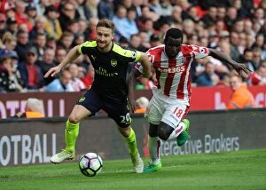 Images Dated 13th May 2017: Mustafi vs Diouf: Intense Battle in Stoke City vs Arsenal Premier League Clash