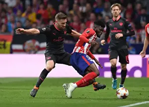 Atletico Madrid V Arsenal 2017-18 Prints: Mustafi vs. Partey: Intense Clash in Arsenal's Europa League Semi-Final Battle against Atletico Madrid