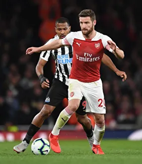 Arsenal V Newcastle United 2018-19 Prints: Mustafi's Powerful Showdown: Arsenal Defender Overpowers Rondon in Intense Clash (Arsenal vs Newcastle United)