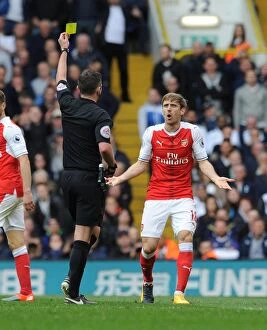 Images Dated 30th April 2017: Nacho Monreal Shown Yellow Card by Referee Michael Oliver in Tottenham Hotspur vs Arsenal Premier