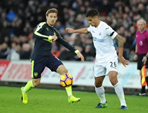 Swansea City V Arsenal - 2016-17 Prints: Nacho Monreal vs. Kyle Naughton: Intense Battle in Swansea City vs
