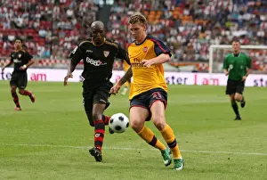 Arsenal V Seville Prints: Nicklas Bendtner (Arsenal) Aquivaldo Romana (Seville)