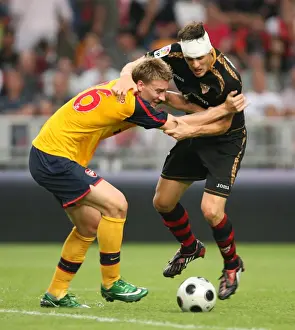 Arsenal V Seville Prints: Nicklas Bendtner (Arsenal) Sebastien Squillaci (Seville)