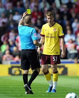 Stoke City v Arsenal 2010-11 Collection: Nicklas Bendtner (Arsenal) is shown the yellow card. Stoke City 3: 1 Arsenal