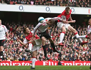 Nicklas Bendtner jumps above Peter Crouch to head in the Arsenal goal