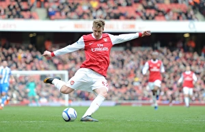 Images Dated 30th January 2011: Nicklas Bendtner shoots past Huddersfield goalkeeper Ian Bennett to score the 1st Arsenal goal