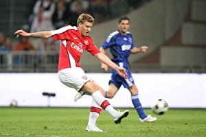 Ajax V Arsenal Prints: Nicklas Bendtner shoots past Maarten Stekelenburg to