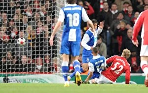 Arsenal v FC Porto 2009-10 Collection: Nicklas Bendtner shoots past Porto goalkeeper Helton to score the 1st Arsenal goal