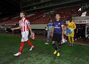 Images Dated 12th September 2012: Nico Yennaris and Konstantinos Rougkalas Lead Out Teams at Olympiacos vs