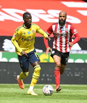 Sheffield United V Arsenal - FA Cup 2019-20 Prints: Nicolas Pepe Breaks Past David McGoldrick: Arsenal vs Sheffield United - FA Cup Quarterfinal Showdown