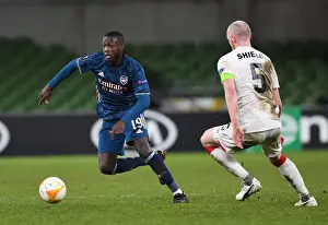 Dundalk V Arsenal 2020-21 Prints: Nicolas Pepe Breaks Past Dundalk's Chris Shields in Arsenal's UEFA Europa League Clash