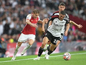 Images Dated 26th August 2023: Odegaard vs. Palhinha: A Premier League Battle at Emirates Stadium