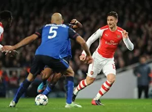 Arsenal v Monaco 2104/15 Collection: Olivier Giroud (Arsenal) Aymen Abdennour (Monaco). Arsenal 1: 3 AS Monaco. UEFA Champions League