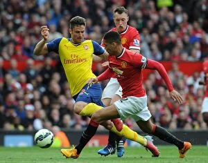 Manchester United v Arsenal 2014-15 Collection: Olivier Giroud (Arsenal) Chris Smalling and Phil Jones (Man Utd). Manchester United 1: 1 Arsenal