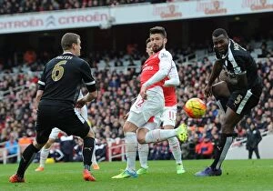 Images Dated 14th February 2016: Olivier Giroud (Arsenal) heads the ball between Robert Huth and Wes Morgan (Leicester)