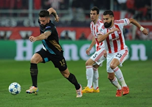 Olympiacos V Arsenal 2015-16 Prints: Olivier Giroud Overpowers Dimitris Siovas: Arsenal's Thrilling Victory over Olympiacos in the UEFA Champions League