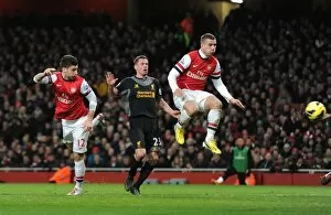 Images Dated 30th January 2013: Olivier Giroud scores Arsenal 1st goal as he gets ahead of Jamie Carragher (Liverpool)
