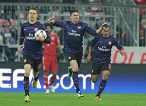 German Soccer League Collection: Olivier Giroud and Theo Walcott Celebrate Arsenal's Goal Against Bayern Munich in Champions League