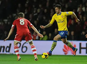 Southampton V Arsenal 2013-14 Prints: Olivier Giroud vs. Steven Davis: Intense Battle in Southampton v Arsenal Premier League Clash