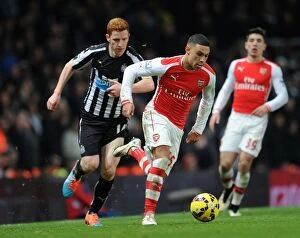 Arsenal v Newcastle United 2014/15 Collection: Oxlade-Chamberlain vs. Colback: A Fight for Supremacy in the Arsenal vs. Newcastle United Clash