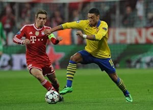 Bayern Munich v Arsenal 2013-14 Collection: Oxlade-Chamberlain vs. Lahm: The Battle at the Allianz Arena - Arsenal vs