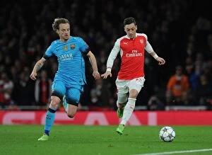 Arsenal v Barcelona 2015/16 Collection: Ozil vs. Rakitic: A Champions League Showdown - Arsenal's Mesut Ozil Clashes with Barcelona's Ivan