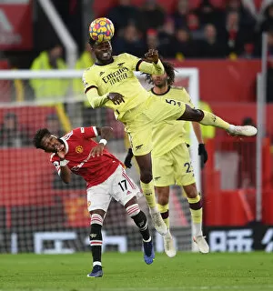 Manchester United v Arsenal 2020-21 Collection: Partey vs. Fred: Intense Heading Battle at Old Trafford - Manchester United vs