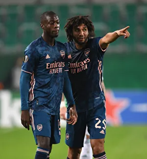 Rapid Vienna V Arsenal 2020-21 Prints: Pepe and Elneny in Action: Arsenal vs Rapid Vienna, UEFA Europa League 2020-21